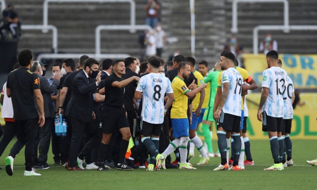 Chaos on the pitch as play is interrupted after Brazilian health officials objected to the participation of three Argentine players they say broke quarantine rules.