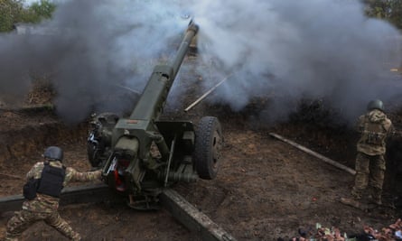 Members of the Ukrainian National Guard fire a D-30 howitzer towards Russian troops in Kharkiv region