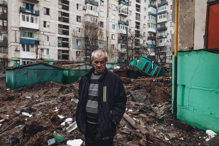 A Ukrainian man stands among the ruins at a residential area damaged by shelling in Lysychansk, Ukraine