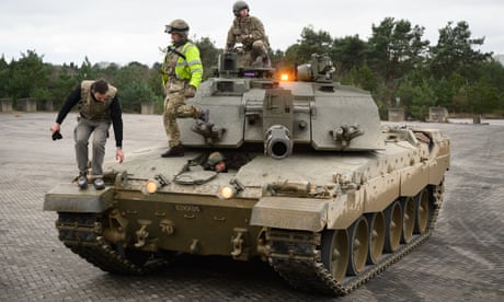 Ukrainian recruits and their British trainers complete a session on the operation of a Challenger 2 tank at a military facility in southern England