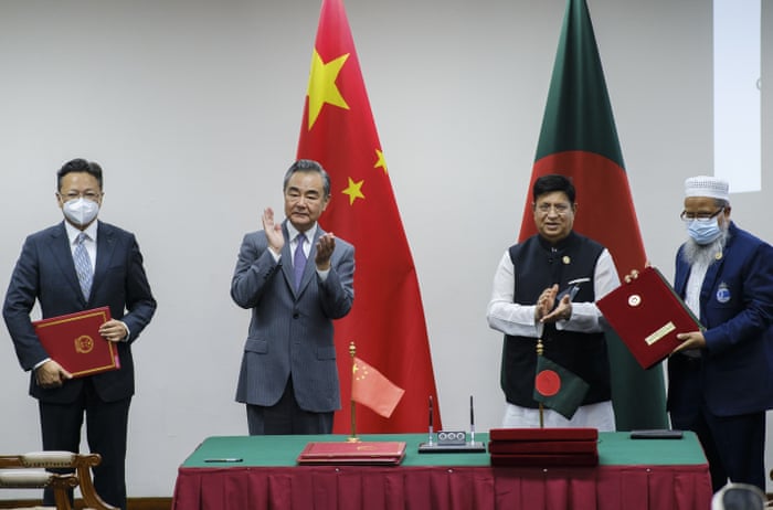 Chinese foreign minister Wang Yi, centre left, and his Bangladeshi counterpart A K Abdul Momen applaud as both countries sign agreements in Dhaka, Bangladesh.