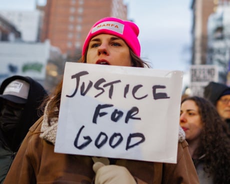woman holds sign saying 'justice for good' at protest