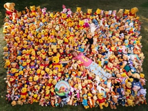 Deb Hoffmann in sea of Winnie-the-Pooh and friends toys