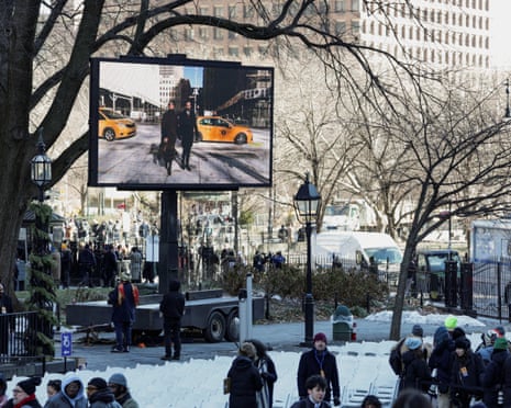 A large screen displays Zohran Mamdani and his wife Rama Duwaji at Old City Hall station.