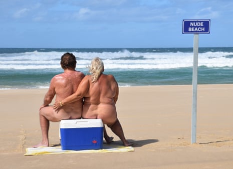 A woman and man sitting on an esky in the nude on Marcus Beach in Queensland's Noosa shire