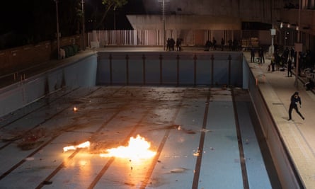 Protesters at a Hong Kong university throw Molotov cocktails into an empty swimming pool.