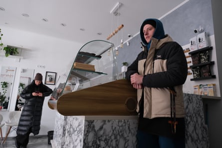 Oleksandr Bartkov in a cafe wearing a hoodie and ski jacket