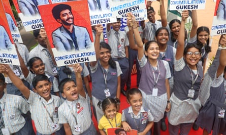 School students in Chennai waving placards congratulating Gukesh on becoming world chess champion.