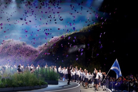 Flagbearer Alex Marshall and King's baton bearer Sarah Adlington lead out the Scotland team.