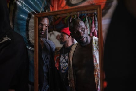 Men look into a mirror