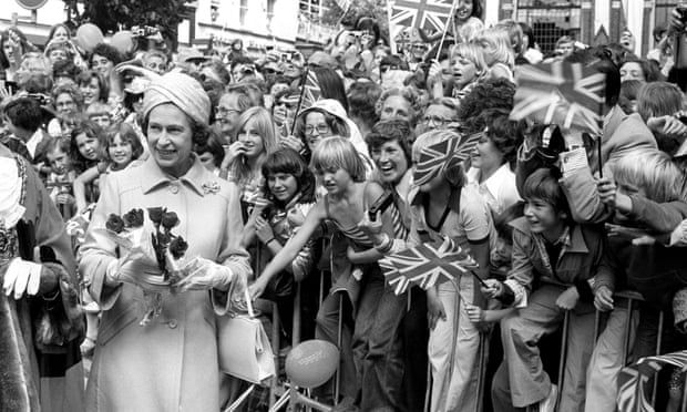 The Queen receiving flowers during a walkabout among the crowds in Ipswich, Suffolk, during her silver jubilee tour of Britain in 1977.