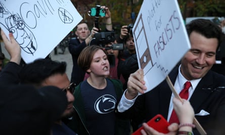 Alex Stein grabs a protester's sign outside Penn State University in State College, Pennsylvania, on October 24, 2022.