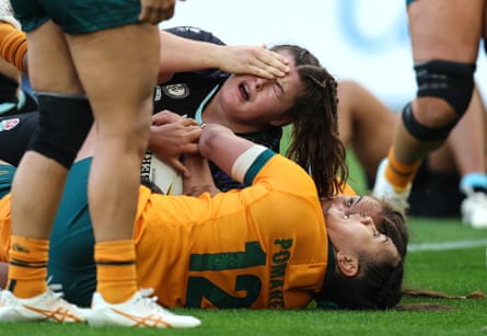 Maud Muir of England holds her head after a high tackle.