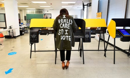 Tonya Swain votes in Norwalk, California, while wearing a coat that mimics one worn by Melania Trump in 2018 which read, “I really don’t care. Do u?”