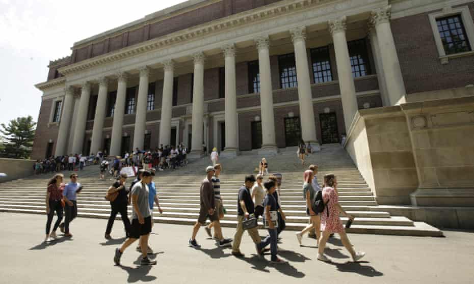 People walk past an entrance to Widener Library on the campus of Harvard University.