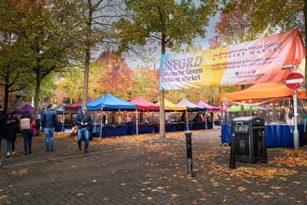 Market stall set up under autumnal trees in Oxford