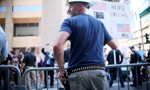 A pro-Trump supporter holds a firearm in Phoenix