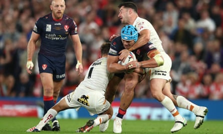 Sione Mata’utia of St Helens is tackled by two Catalans Dragons.