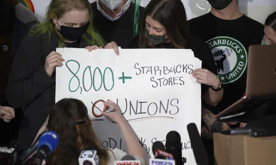 Starbucks employees alter a campaign sign during a press conference in Buffalo, New York, in December.