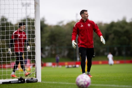 Tom Heaton takes his place in goal during a training session at Carrington