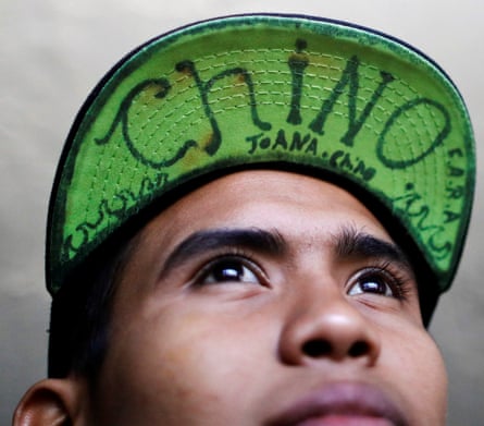 David, 15, poses for a photo at the end of the caravan’s trip in Tijuana, 26 April. The words read ‘Chinese’