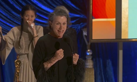 Frances McDormand, winner of the best actress award for Nomadland, with director Chloé Zhao in the background.