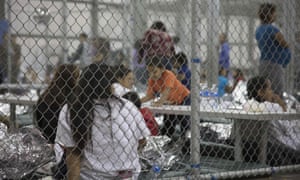 People are held by US Border Patrol agents at the Central Processing Center in McAllen, Texas.