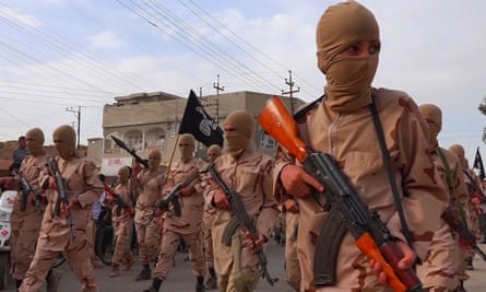 Boys known as the “caliphate cubs” hold rifles during a parade near Mosul in Iraq.