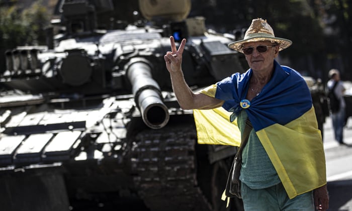 A Ukrainian man poses for a photo with a tank during the Ukraine's 31st Independence Day in Kyiv.