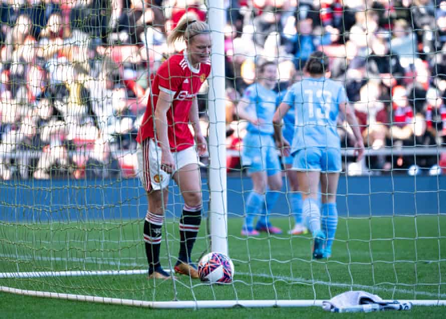 Manchester United's Diane Caldwell kicks the ball out of the net after Ellen White scores City's second goal.