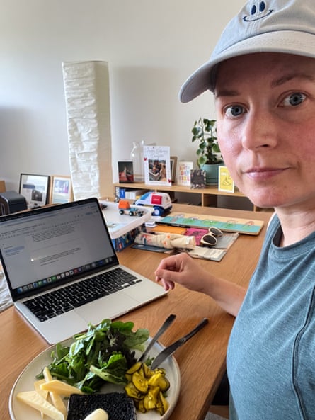 Emma Joyce sitting at her desk as she eats her lunch