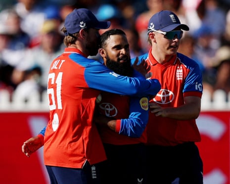 England's Adil Rashid (centre) celebrates with teammates after taking the wicket of India's Abhishek Sharma.