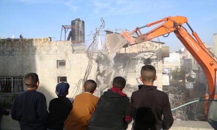 A heavy duty machine demolishes a house damaged by a rocket launcher during a raid carried out by the Israeli forces on Jan. 26, in Jenin, West Bank on 31 January 2023.