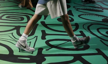A model walks the runway wearing the Christian Dior pre-fall 2020 men's fashion collection shoe Air Dior during Miami Art Week.