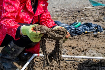 A volunteer holds up a clump of wet wipes.