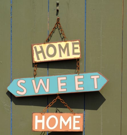 Home sweet home sign hanging on a door
