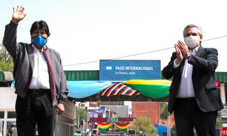 Evo Morales, left, waves goodbye next to Argentina’s president, Alberto Fernández, in La Quiaca, Argentina, on 9 November.