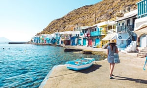 Woman walking in the colorful fishermens village of Klyma, Milos, Greece.
