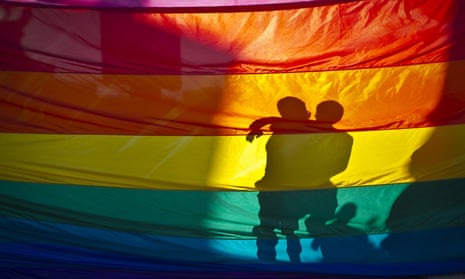 Shadow of couple through rainbow flag