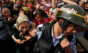 A crowd of locals confronting security forces in Urumqi in 2009.