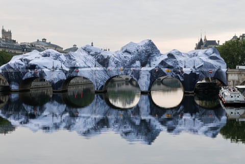 An inflatable artwork conceived by the French street artist JR as a tribute to Christo and Jeanne-Claude, covers the Pont Neuf in Paris.