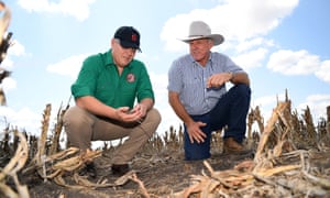 Scott Morrison (left) inspects the dry soil with farmer David Gooding on his drought-affected property near Dalby in Queensland.