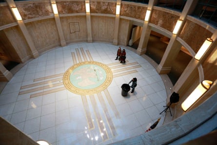 Round, vaunted building with natural light from above lighting an illustration on the ground.
