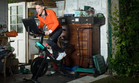 Richard Godwin on his Peloton bike in his garage, wearing an all-weather jacket by Soar (matchesfashion.com), all other clothes are his own.