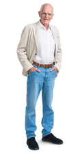 An older, white man in jeans, white shirt and light blazer