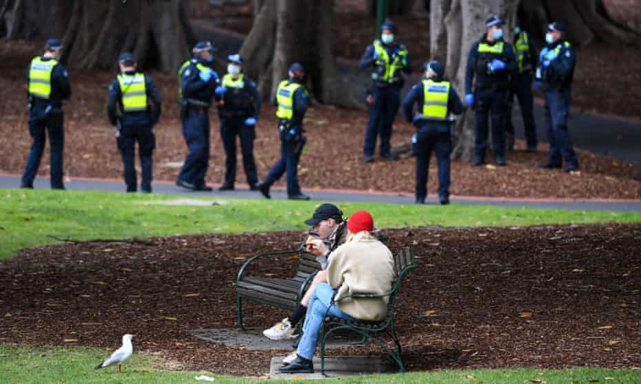 A couple enjoy a break while police patrol through Treasury Gardens in Melbourne over the weekend. During Victoria’s first wave of coronavirus, approximately 42% of those fined for breaching gathering rules were under the age of 24.