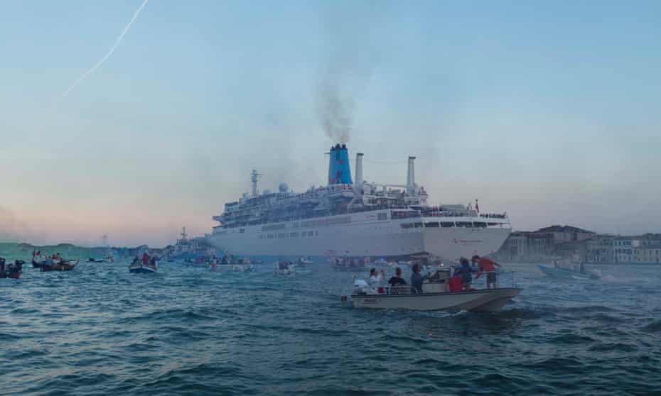 Demonstrators in boats try to block the passage of large ships to demonstrate against their impact on Venice