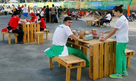 Members of the Turkmenistan team eat McDonald’s food inside the Rio Olympic village