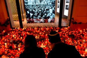 Prague, Czech Republic: a couple light a candle at a memorial to commemorate the 29th anniversary of the Velvet Revolution