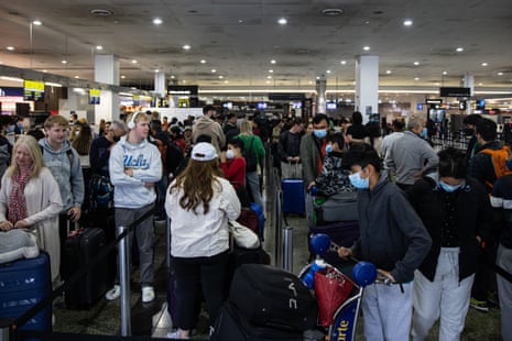 Passengers queue at Melbourne International Airport in June. International passengers could once again face delays as baggage handlers strike over pay and conditions.